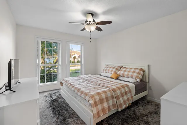 a bed sitting in a bedroom next to a window