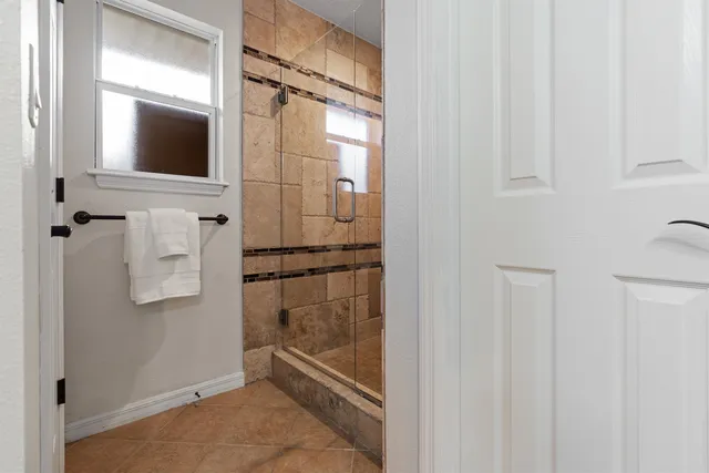 a bathroom with a shower and a mirror