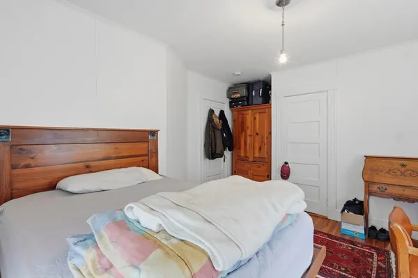a bedroom with a bed and a closet
