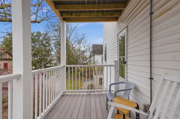 a view of a balcony with wooden floor