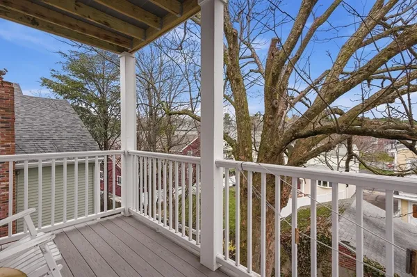 a view of a wooden deck next to a yard