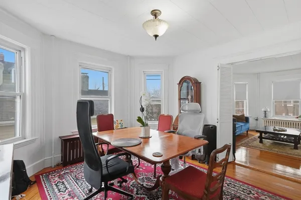 a view of a livingroom with furniture and a dining table