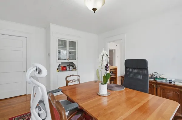 a dining room with table and wooden floor