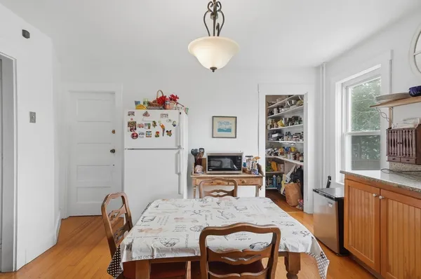 a dining room with furniture and window