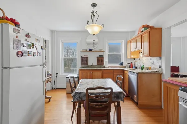a kitchen with stainless steel appliances granite countertop a refrigerator and a stove top oven