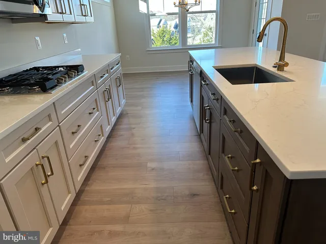 a kitchen with granite countertop a sink and a stove
