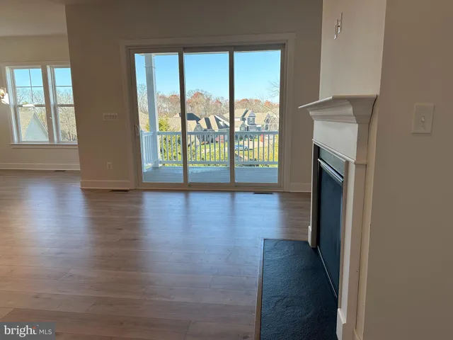 a view of hallway with wooden floor and fireplace