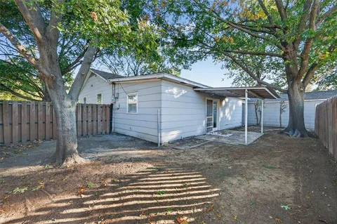 a front view of a house with a tree