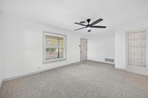 a view of empty room with ceiling fan