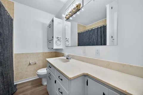 a view of a kitchen with wooden floor and a ceiling fan