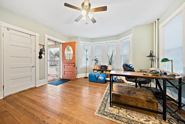 a living room with furniture and wooden floor