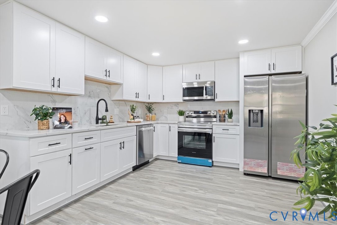 1701 Arlington Road Hopewell, VA 23860 - Photo 2 of 29 a kitchen with cabinets stainless steel appliances and wooden floor