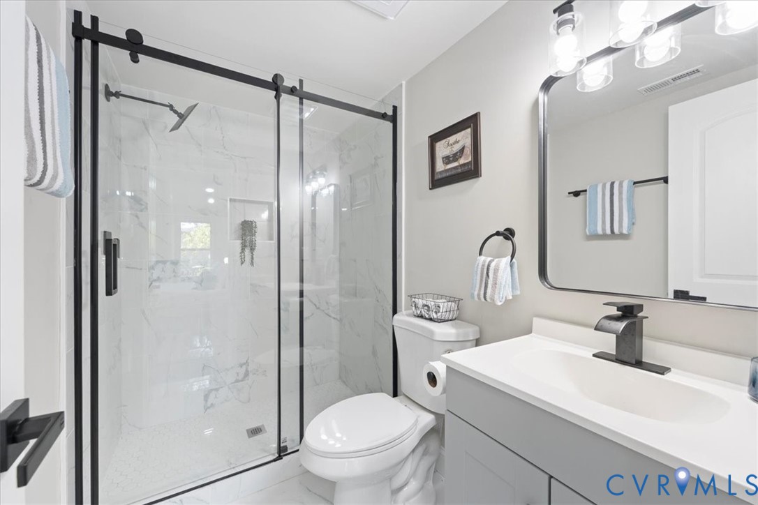 1701 Arlington Road Hopewell, VA 23860 - Photo 29 of 29 a bathroom with a shower sink vanity mirror and toilet