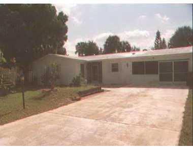 351 Southwest Indian Grove Drive Stuart, FL 34994 - Photo 1 of 1 a view of house with backyard and trees in the background