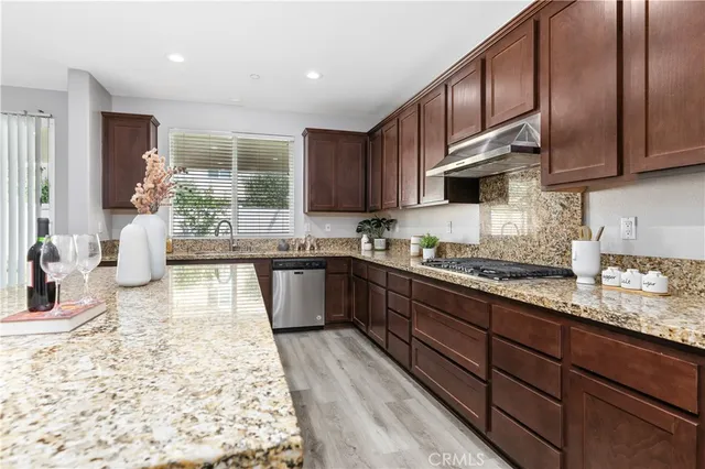 a large kitchen with granite countertop wooden cabinets a granite counter tops and a view of living room