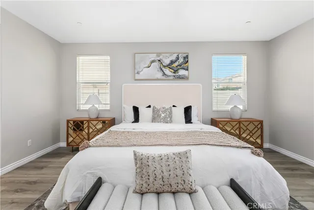 a bedroom with a bed and wooden floor