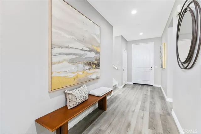 a view of a hallway with wooden floor and door