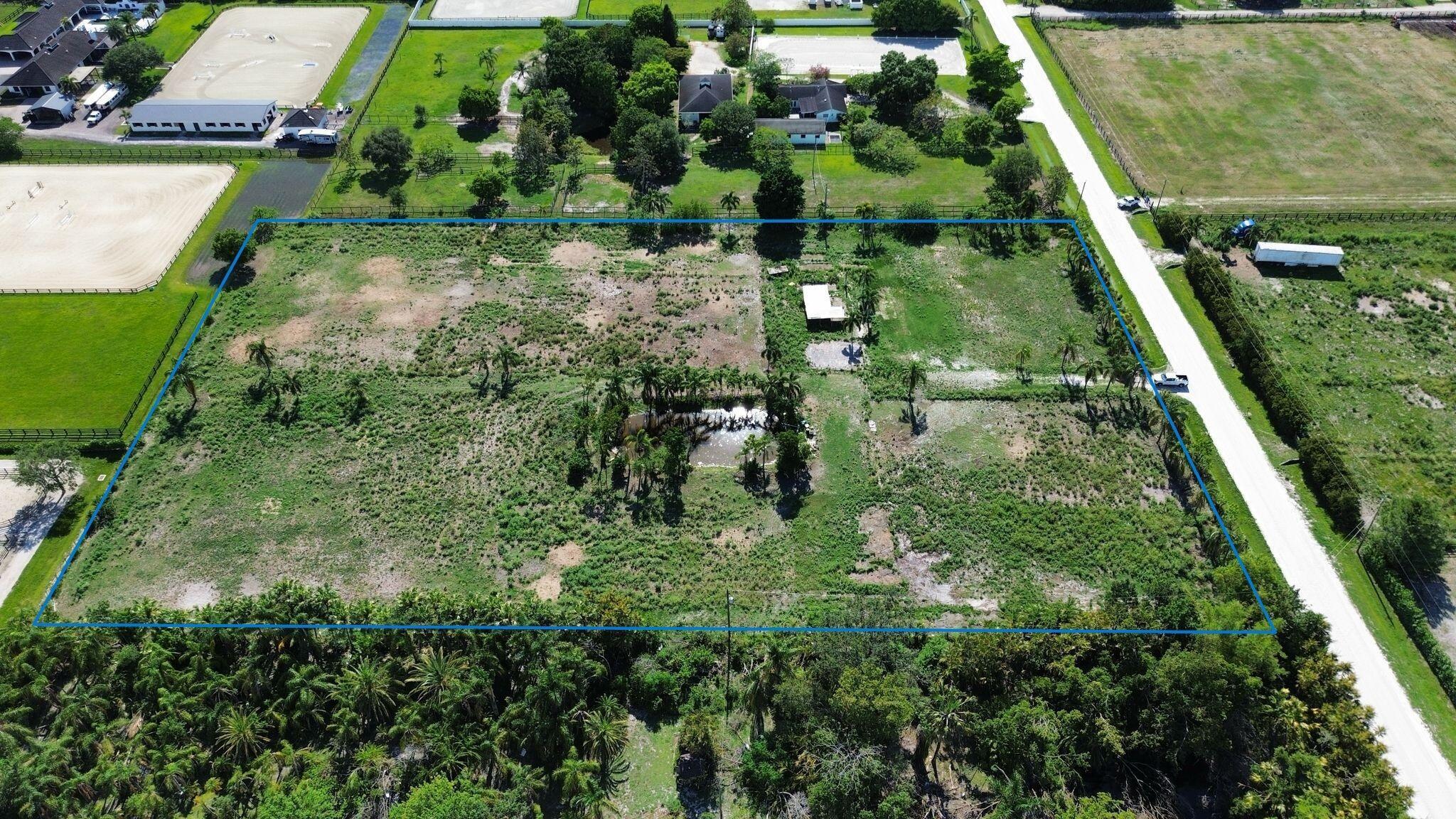 16290 Rustic Road Wellington, FL 33470 - Photo 2 of 20 a backyard of a house with lots of green space