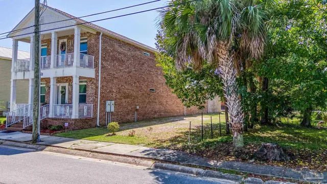 a brick building with a tree in front of it