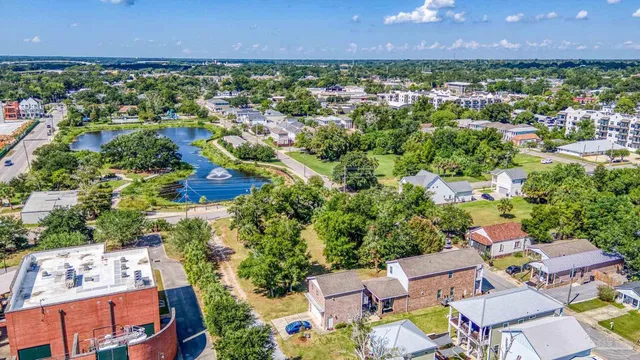 an aerial view of residential houses with outdoor space and trees