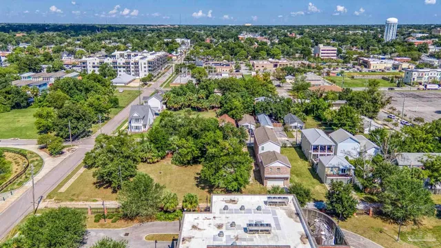 an aerial view of residential houses with outdoor space and street view