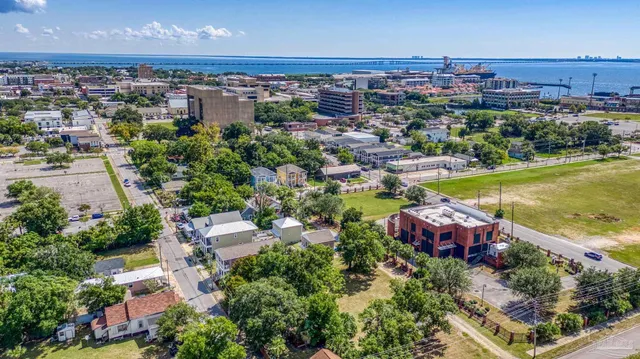 an aerial view of a house with a garden and lake view