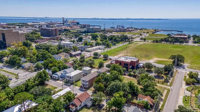an aerial view of a houses with a lake view