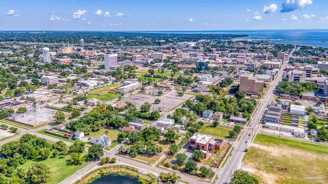 an aerial view of residential houses with outdoor space and swimming pool