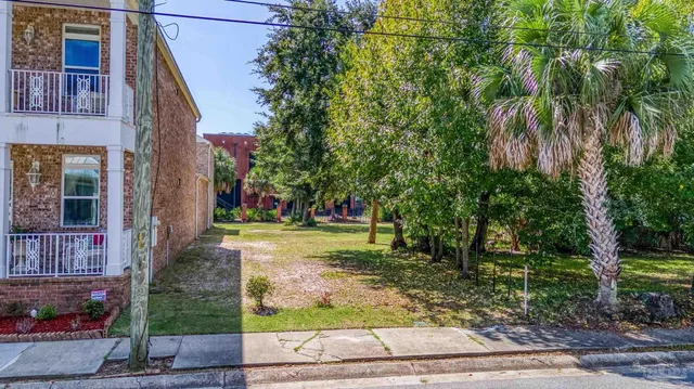 a view of a yard in front of a brick building