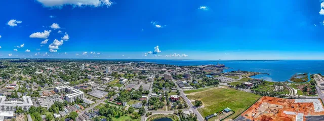 an aerial view of residential houses with outdoor space and swimming pool