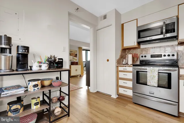 a kitchen with stainless steel appliances a stove a microwave and cabinets