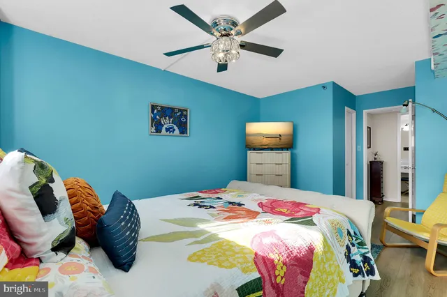 a bedroom with a bed and a chandelier