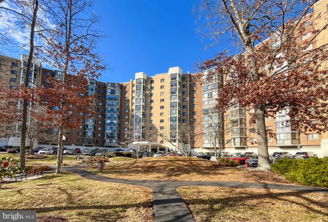 a view of a building with snow on the road