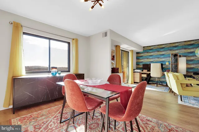 a view of a dining room with furniture window and wooden floor