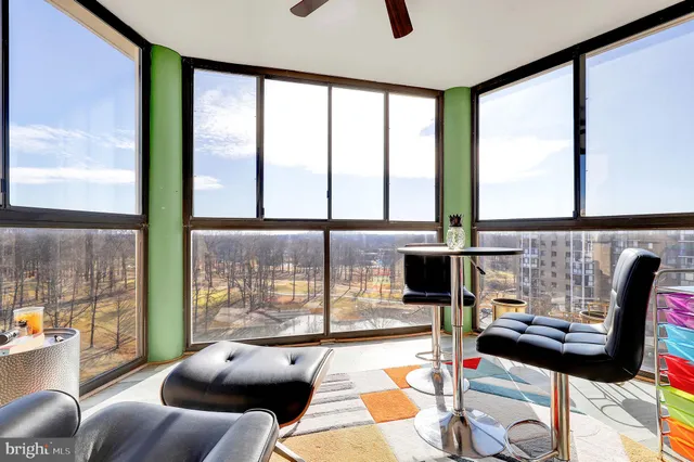 a living room with furniture and a floor to ceiling window