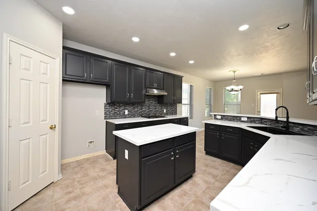 a kitchen with a sink and cabinets