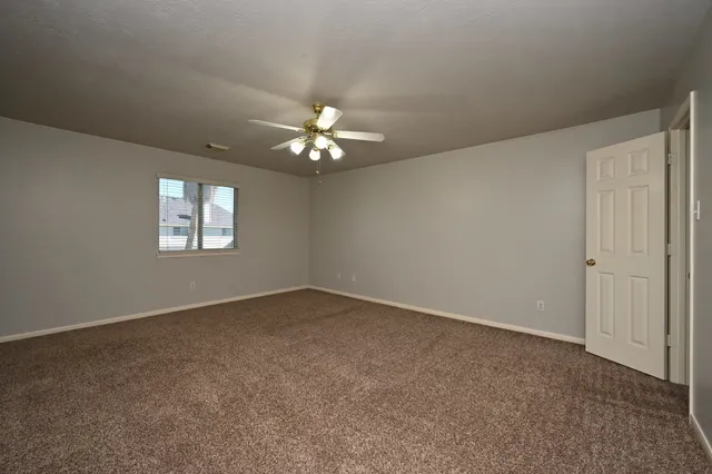 a spacious bedroom with a bed and a couch