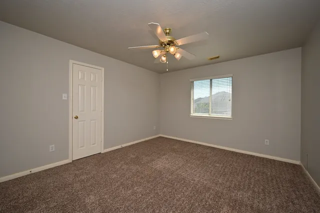 a bathroom with a granite countertop double vanity sink and a mirror