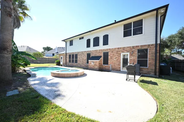 a swimming pool with some tall trees