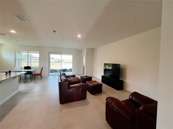 a living room with furniture window and a flat screen tv
