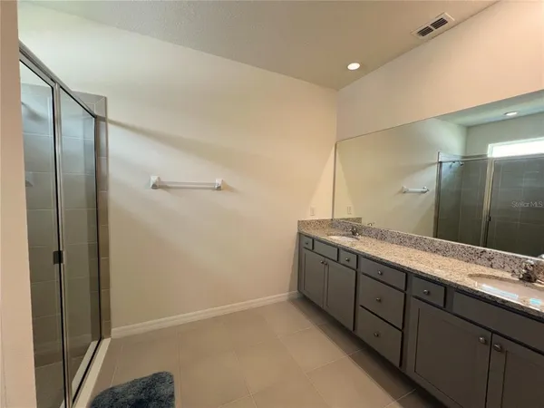 a bathroom with a granite countertop sink mirror and double
