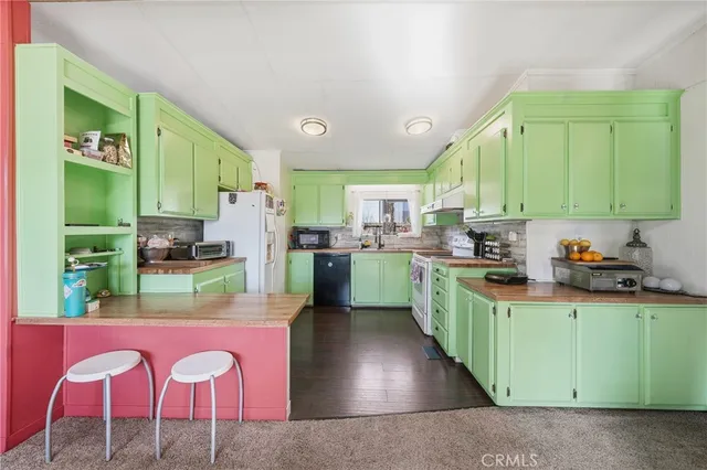 a kitchen with stainless steel appliances granite countertop a sink and cabinets