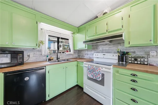 a kitchen with cabinets a sink and appliances