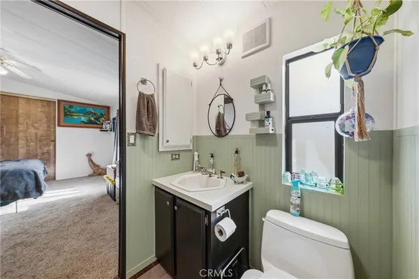 a bedroom with furniture and a flat screen tv