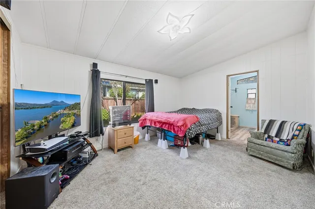 a bedroom with a bed and dresser with mirror