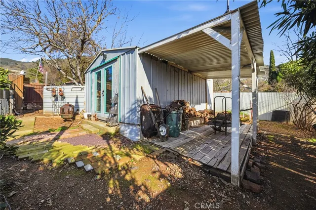 a view of a house with backyard and sitting area