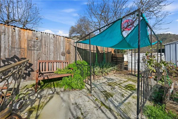 a view of a house with a bench in patio
