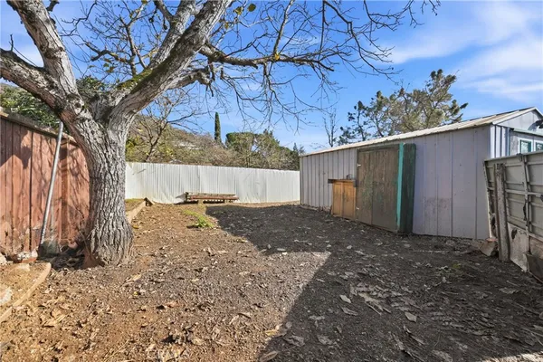 a view of a house with backyard and sitting area