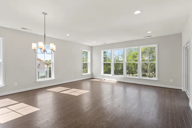 a view of a living room and kitchen with furniture appliances