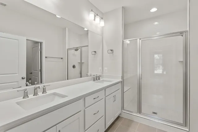a bathroom with double sink and a mirror
